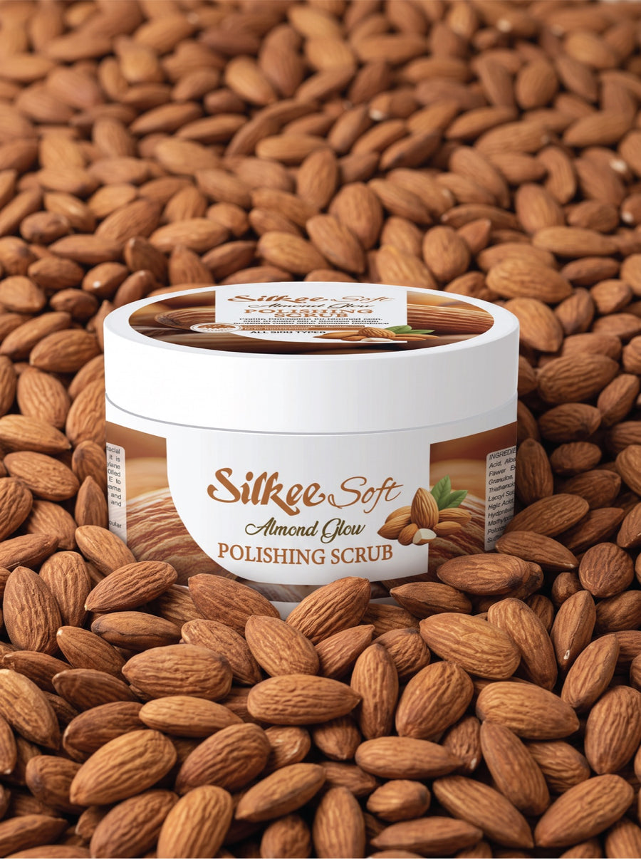 Silkee Soft Almond Glow Polishing Scrub jar resting on whole almonds